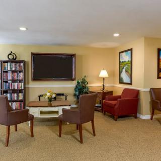 Cozy living room with a seating area and bookshelf.