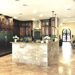 A spacious kitchen interior with a central island and wooden cabinets.
