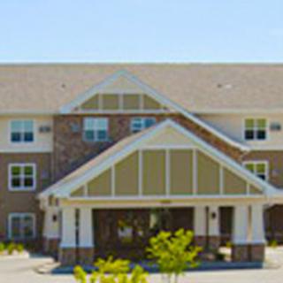 A residential building with a pitched roof and entrance canopy.