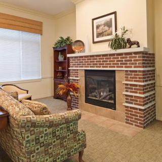 Cozy living room with a brick fireplace and comfortable seating.