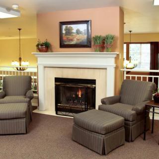 A cozy living room featuring a fireplace and comfortable seating.