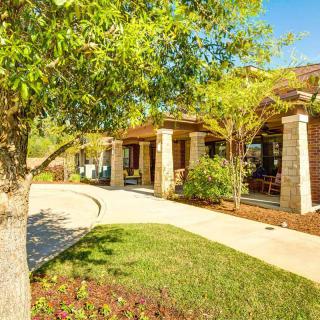 A charming house with a landscaped garden and a sunlit pathway.