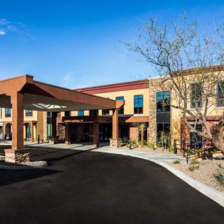 A modern commercial building with a welcoming entrance and landscaped surroundings.