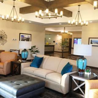 A well-decorated lobby with cozy seating and elegant chandeliers.