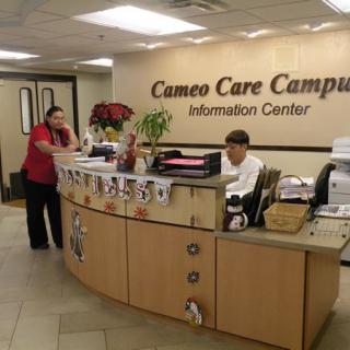 A reception area at the Cameo Care Campus, featuring an information desk with staff members.