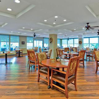 Spacious dining area with wooden floors and ample natural light.