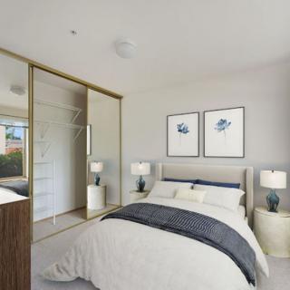 A modern and minimalist bedroom featuring a comfortable bed, stylish lamps, and framed artwork.