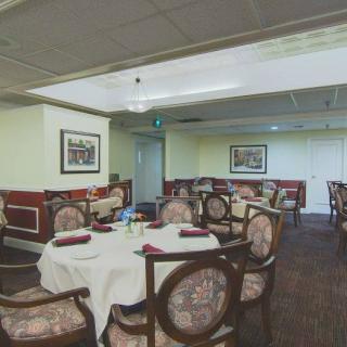 An elegant dining area in a restaurant with neatly arranged tables and chairs.
