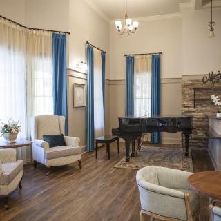 An elegant living room featuring a grand piano and classic decor.