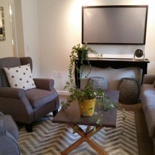 A cozy and modern living room setup with comfortable seating, a stylish coffee table, and decorative plants.