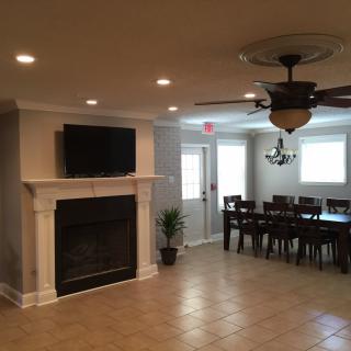 A spacious living room with a fireplace and a dining area.