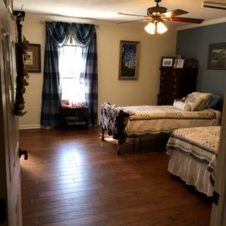 A cozy bedroom featuring twin beds and traditional decor.