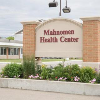 Mahnomen Health Center sign displaying its name and welcoming visitors.