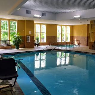 A serene indoor pool area featuring natural light and a welcoming atmosphere.
