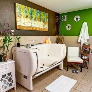 A well-decorated spa bathroom with a modern bathtub and vibrant wall colors.