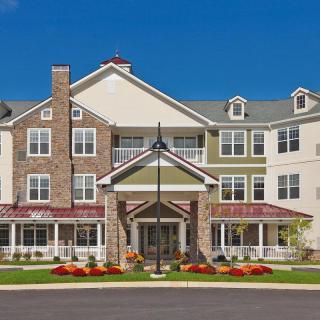A multi-story residential building with a welcoming entrance and well-maintained landscaping.