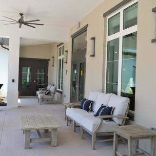A spacious patio with comfortable outdoor seating and a ceiling fan.