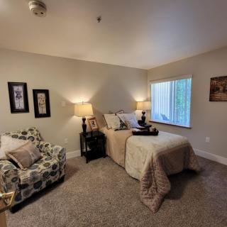 A cozy bedroom with stylish decor and warm lighting.