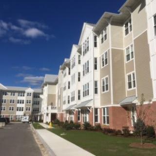 A modern apartment complex under a clear blue sky.