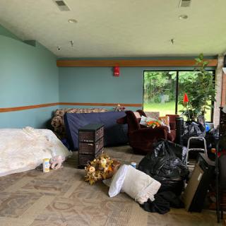 A cluttered indoor space filled with furniture and miscellaneous items.