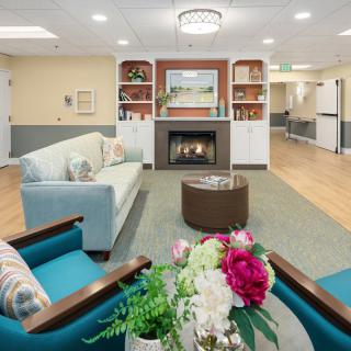 A cozy living room with a fireplace, comfortable seating, and decorative elements.