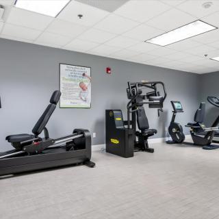 A well-equipped gym featuring various exercise machines for fitness enthusiasts.