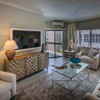 A modern living room with stylish decor, featuring a cozy seating area and entertainment setup.