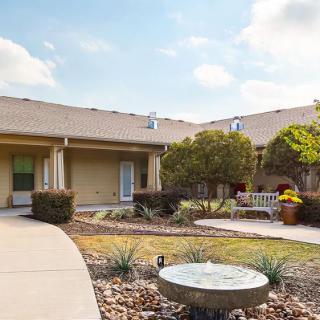 A serene courtyard with outdoor seating and landscaped garden.