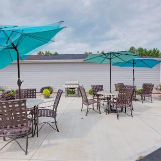 A cozy outdoor patio area with turquoise umbrellas and comfortable seating, perfect for relaxation.