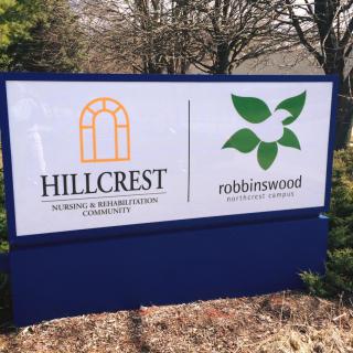 A sign for Hillcrest Nursing & Rehabilitation Community and Robbinswood Assisted Living Community.