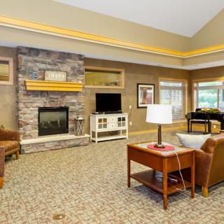A cozy living room with a fireplace, television, and comfortable seating.