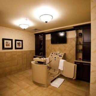 A luxurious spa room featuring a comfortable massage chair and elegant interior design.