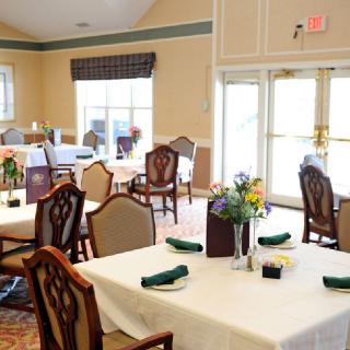 An elegantly set dining area with neatly arranged tables and chairs.