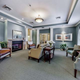 A well-decorated living room with comfortable seating and a fireplace.