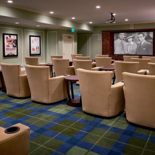A cozy home theater with plush seating and a large screen for viewing movies.