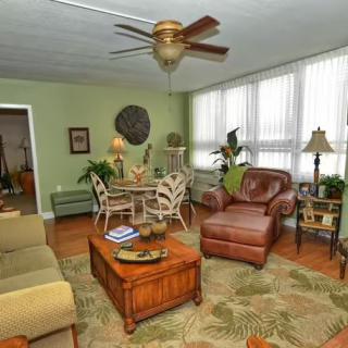 A cozy living room with comfortable seating, lush plants, and tasteful decor.
