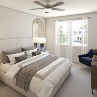 A modern and minimalist bedroom with a comfortable bed and large windows allowing natural light.