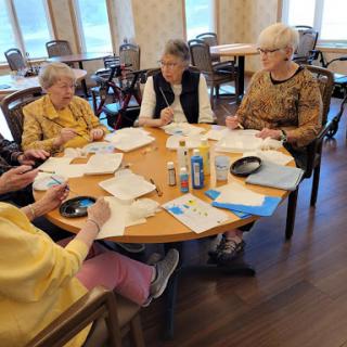 Seniors engaged in a creative activity at a community center.