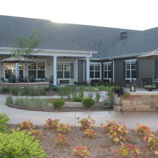 A well-landscaped house with a spacious patio area.