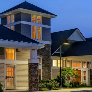 A well-lit house at night showcasing modern architectural design.