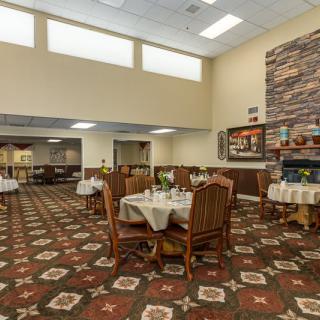 A spacious dining area with elegantly set tables and a warm, inviting atmosphere.