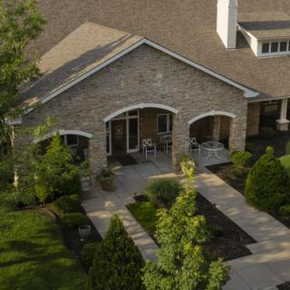 A suburban house with a stone facade and well-maintained landscaping.