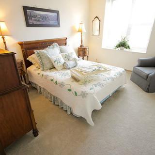 A cozy, well-lit bedroom with elegant decor and a comfortable bed.