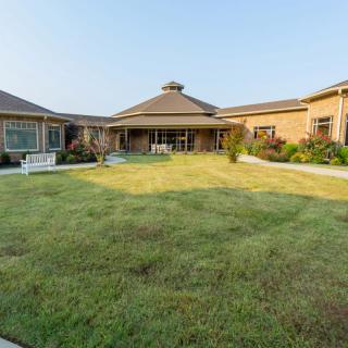 A spacious house with a well-maintained lawn and garden.