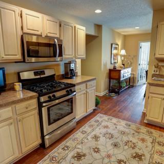 A cozy kitchen with modern appliances and wood flooring.