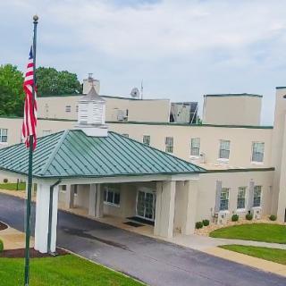 A building with a covered entrance and an American flag displayed.
