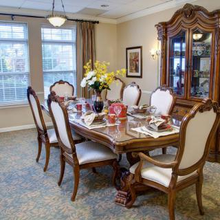 An elegantly furnished dining room with a set table and decorative elements.