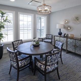 A stylish dining room with a round table and decorative elements.