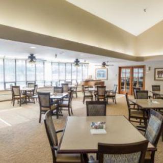 Spacious dining area with multiple tables and large windows.