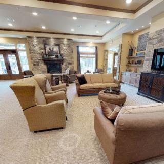 Spacious living room with comfortable seating, a fireplace, and modern decor.